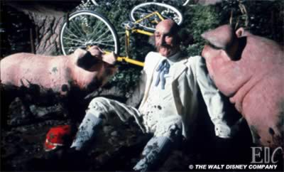 Man with pig friends in a mud